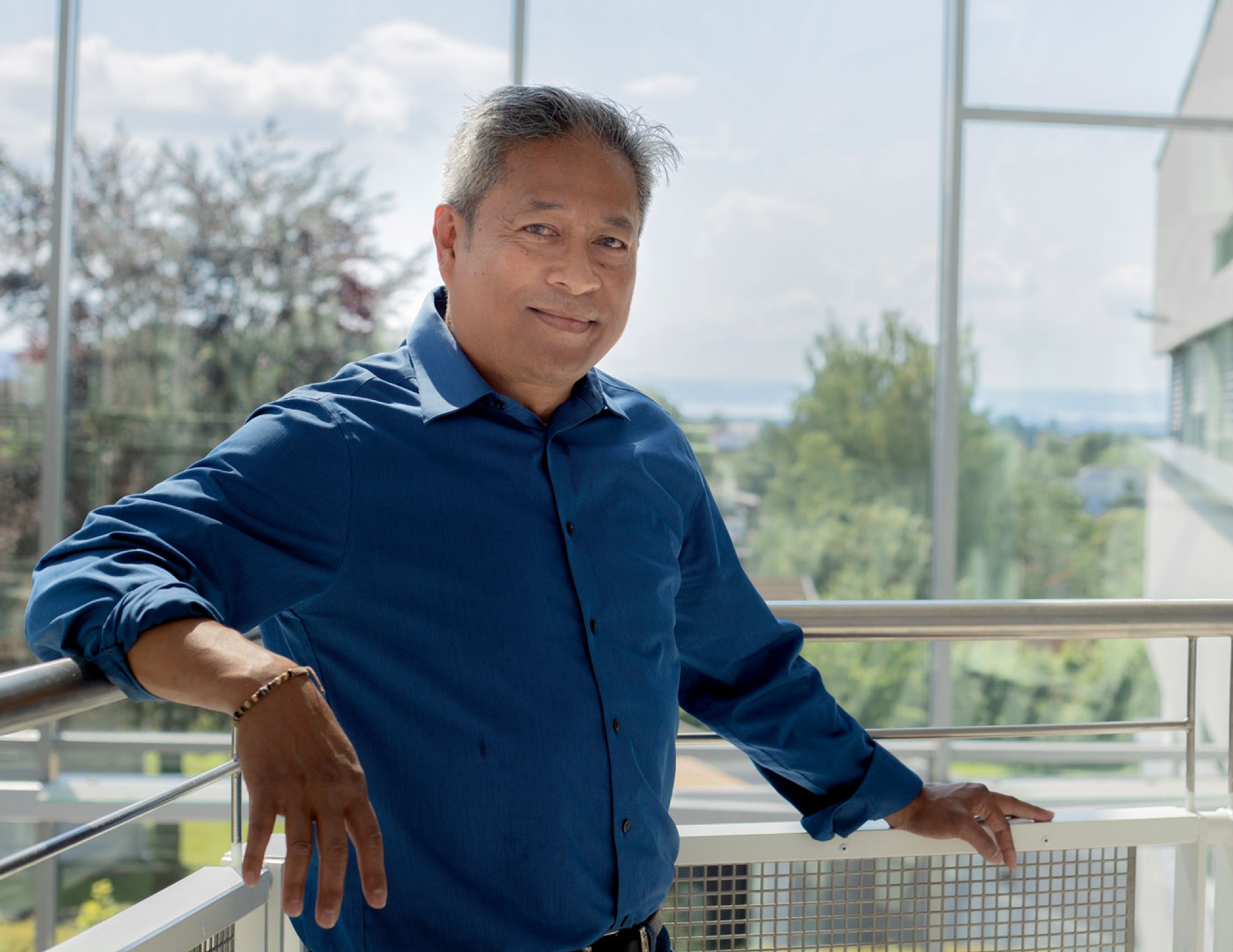 Cipriano Mauricio standing on a balcony